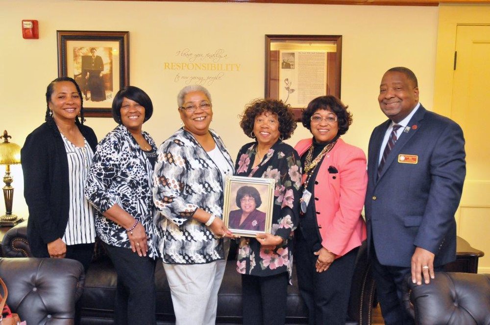 Pictured from left to right are Ms. Denise I. Henson ('79), Mrs. Dorothy Kasey McNeill, Mrs. Darlene E. Holmes ('78), holding the picture of the late Mrs. Mary F. Henson ('83) with Mrs. Mary Diana Sutton ('76), Rev. Dr. Deborah (Dee) Henson-Governor ('73), and Interim President Hubert L. Grimes&nbsp;